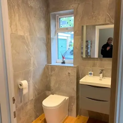 Tiled bathroom with vanity, mirror and storage in the same TJC refurbishment