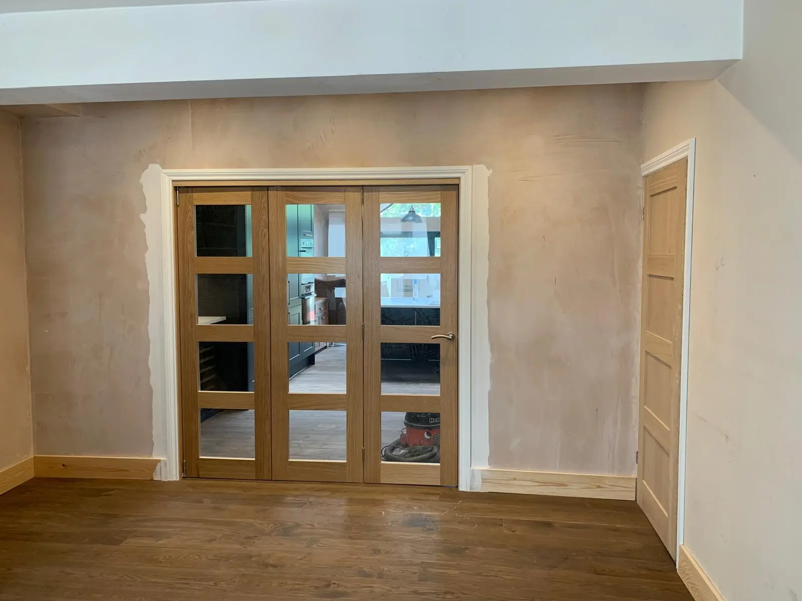 Oak glazed doors installed beside the new kitchen